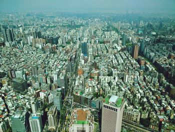 High angle view of modern buildings in city against sky