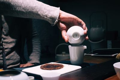 Man holding coffee cup on table