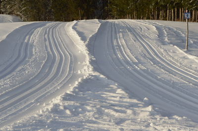 Tire tracks on snow covered field