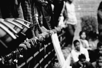 Close-up of human hands on railing