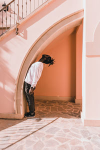 Rear view of man standing at entrance of building