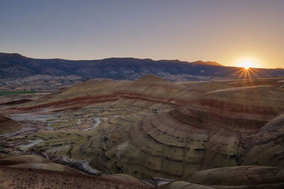 Scenic view of desert against sky during sunset