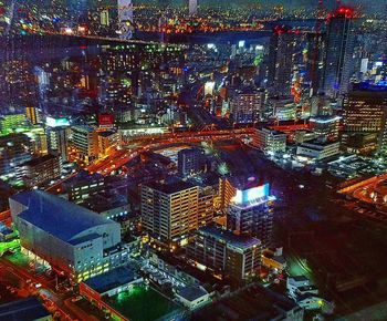 High angle view of illuminated buildings in city at night