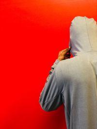 Rear view of person against red background