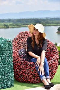 Full length of young woman sitting in lake