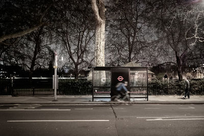 Full length of man on street against trees in city