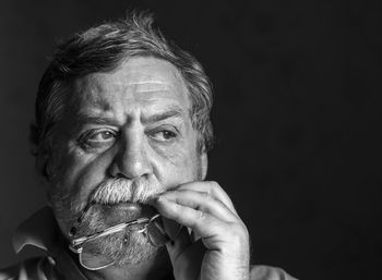 Portrait of mid adult man against black background