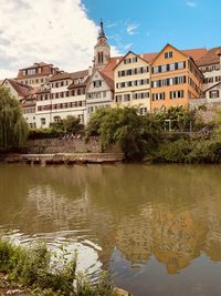 Reflection of buildings and trees in river
