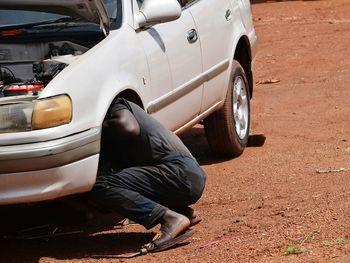 Low section of man in car on street