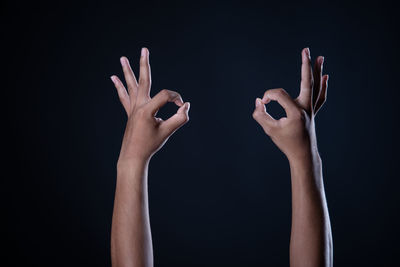 Close-up of hands over black background