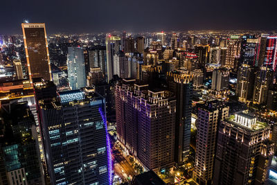 Aerial view of illuminated buildings in city at night