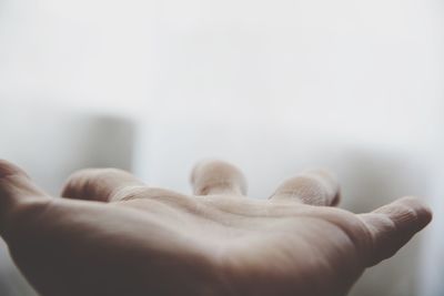 Cropped image of hand against sky