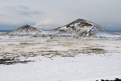 Scenic view of lake against sky during winter