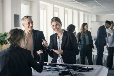 Woman and man picking up their passes before conference