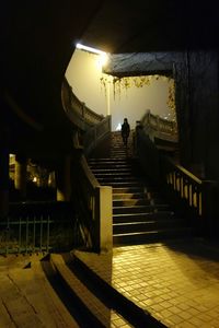 Illuminated walkway at night