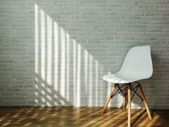 Empty chair against wall at home