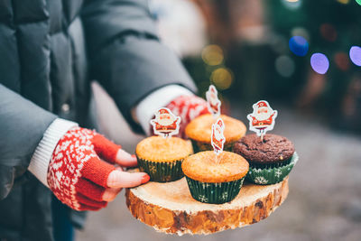 Midsection of man holding cake