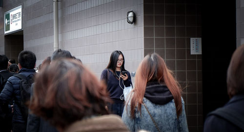 Young woman using mobile phone in city