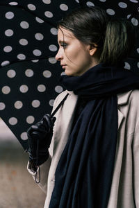 Portrait of young woman standing on field