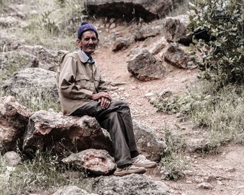 Man sitting on rock