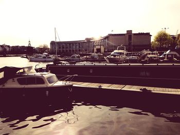 Boats in river with buildings in background