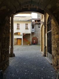 Empty alley amidst buildings in city