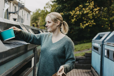 Woman recycling rubbish