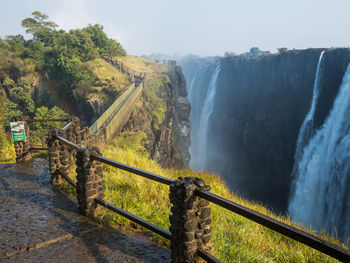 Scenic view of foot path and bridge at victoria falls