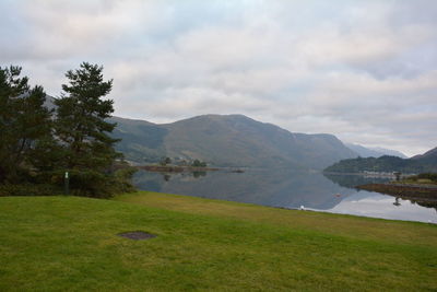 Scenic view of lake against cloudy sky