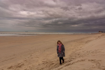 Full length of man on beach against sky