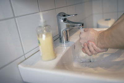 Man washing hands in bathroom