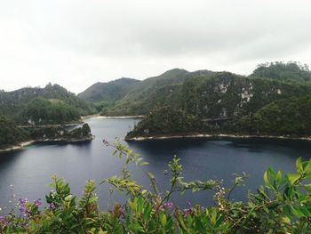 Scenic view of lake and mountains against sky