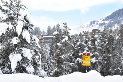 Ski lift over snowcapped mountains against sky