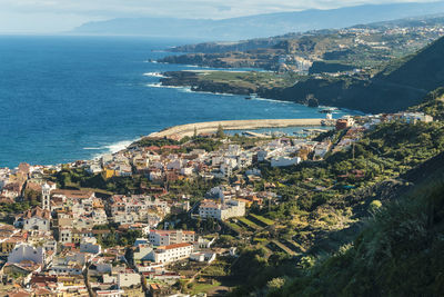 Farm village by the coast of tenerife with blue sea water