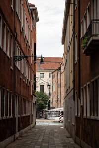 Footpath amidst buildings in city