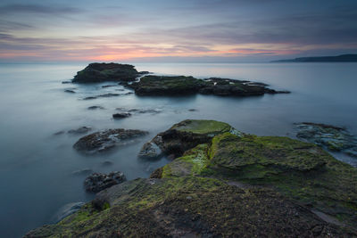 Scenic view of sea against sky at sunset