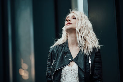 Portrait of young woman looking away outdoors