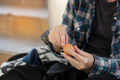 Midsection of man holding ice cream