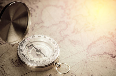High angle view of navigational compass on map