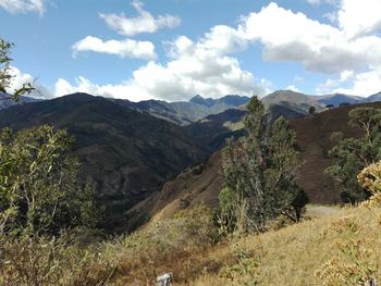 Scenic view of mountains against cloudy sky