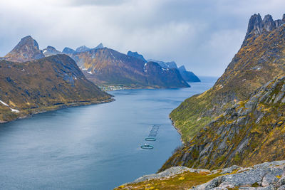 Scenic view of sea and mountains against sky