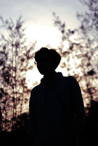 Silhouette man standing against sky during sunset