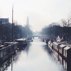 Boats in river with buildings in background
