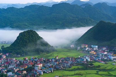 High angle view of buildings and mountains against sky