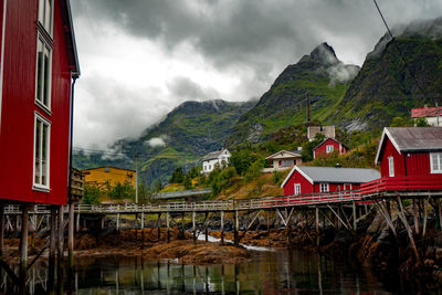 House by lake and mountains against sky in norwau