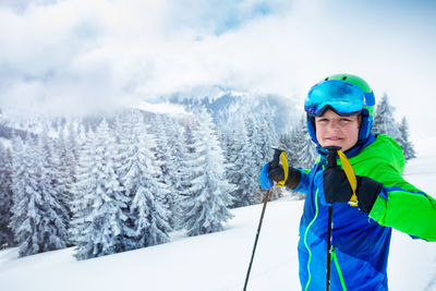 Portrait of boy standing on snow