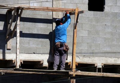 Rear view of man working at construction site