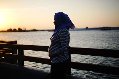 Rear view of woman looking at sea against sky