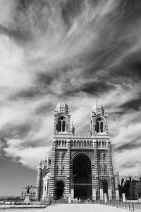 Low angle view of church against cloudy sky