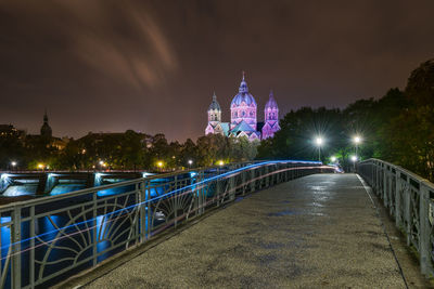 Illuminated bridge against sky at night